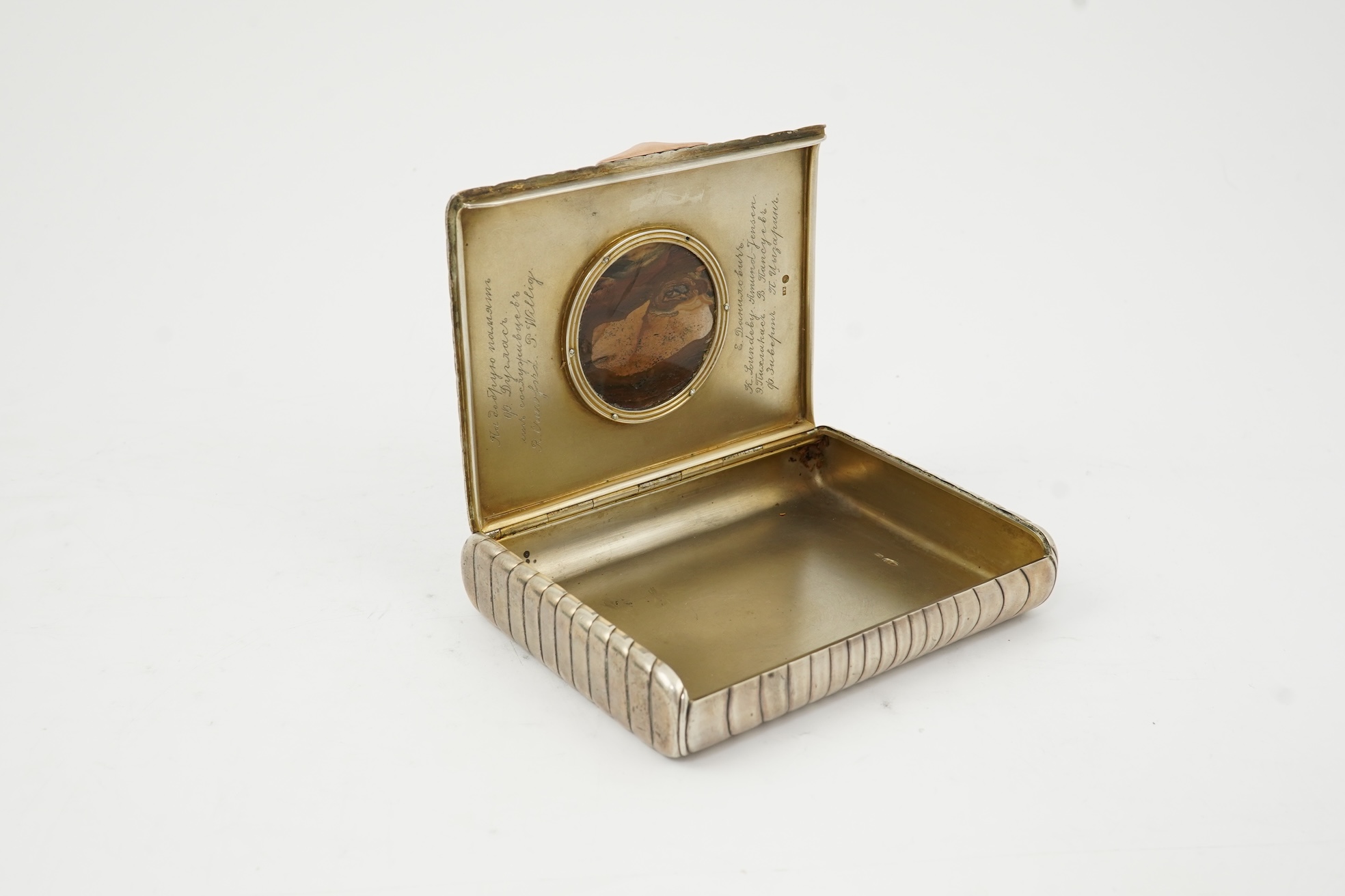 An early 20th century Russian 84 zolotnik silver cigarette case, with cappuccino agate inset cover, of ribbed rectangular form